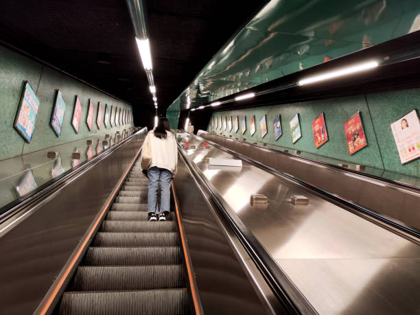 People on Quarry Bay mtr stations's long escalator, Quarry Bay residential area, Hong Kong island.
