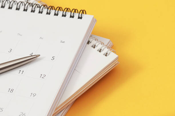 istock A pen with calendar on yellow background 2145102684