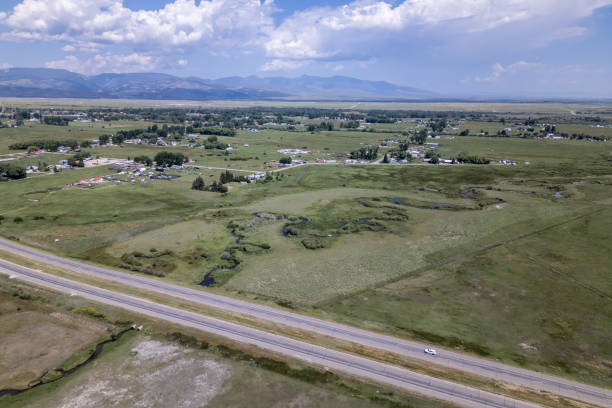istock Expansive Aerial View Over Rural Landscape with Homes, Fields, and Winding River 2145144626