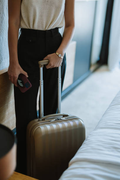 istock Unrecognizable Woman Preparing to Leave a Hotel Room With a Suitcase 2145191613