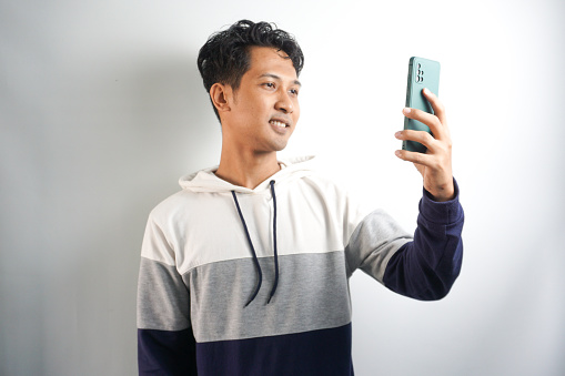 close up of man having video call on smartphone