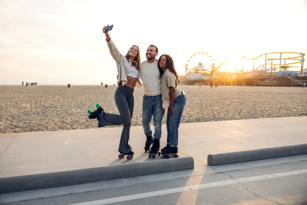 istock Friends roller skating by the beach promenade 2145213445