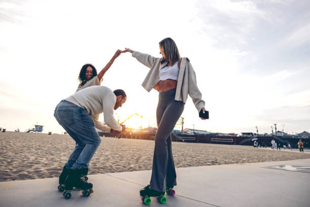 istock Friends roller skating by the beach promenade 2145216018