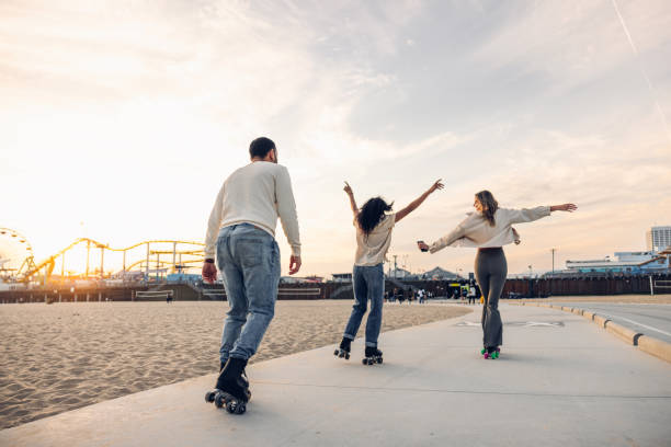 istock Friends roller skating by the beach promenade 2145216531