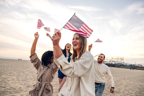 istock People waving US flags for holidays celebration 2145219674