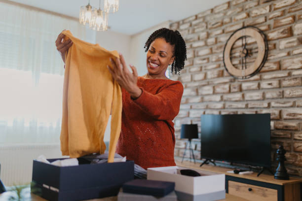 istock Women unpacking items from online shopping 2145226043