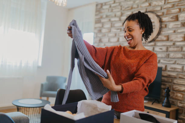 istock Women unpacking items from online shopping 2145226991
