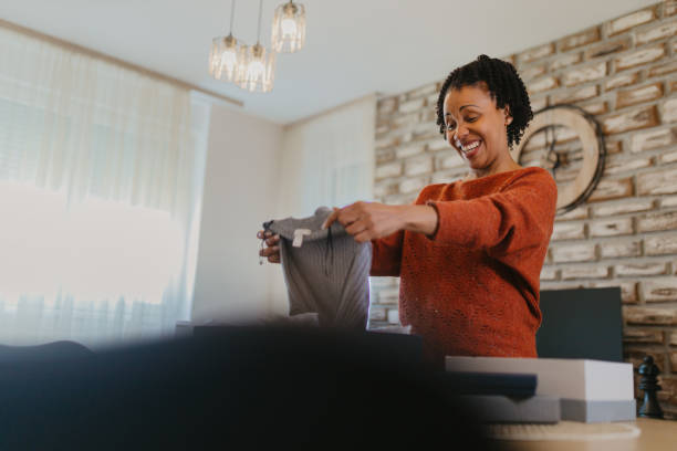 istock Women unpacking items from online shopping 2145227003