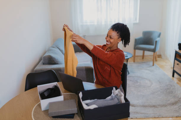 istock Women unpacking items from online shopping 2145233815