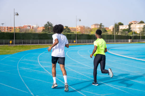istock African american young runners training together in a running track 2145251195