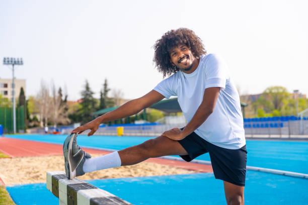 istock Sportive man warming up in an outdoor running track 2145253310
