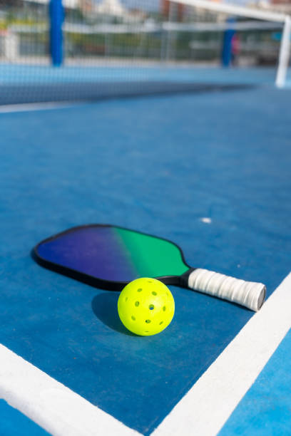 istock Racket and pickleball ball placed on a court ground 2145260279