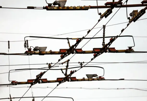 Wires of a trolleybus against a gray sky.