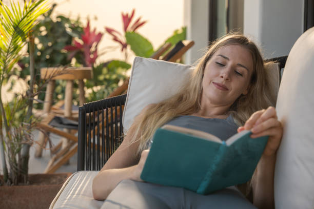 istock A young woman deeply focused on writing in her balcony 2145314734