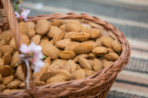 Almond nuts in a basket on a wooden background