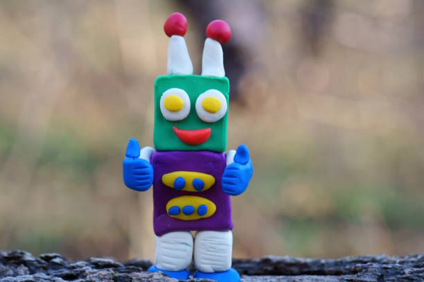 istock A toy robot made of plasticine smiles. 2145345424