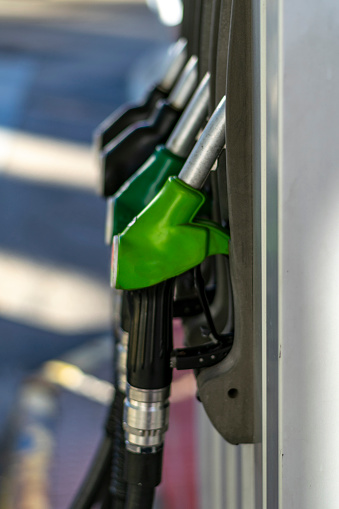 Gasoline and diesel fuel dispenser at the gas station. Gas pump nozzles. Gasoline filling gun close-up at the gas station. Colorful gasoline pump filling nozzles. Fuel pump