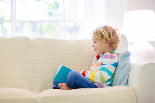 istock Child reading book. Kids read books. 2145354444