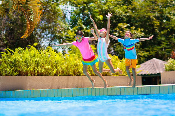 istock Kids jump into swimming pool. Summer water fun. 2145367804