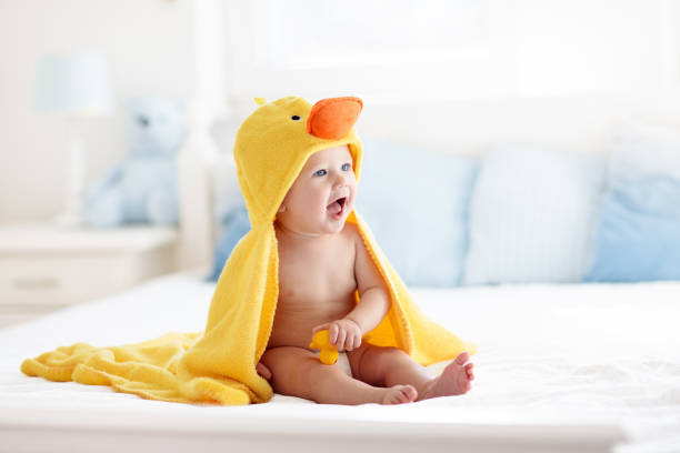 istock Cute baby after bath in yellow duck towel 2145368848