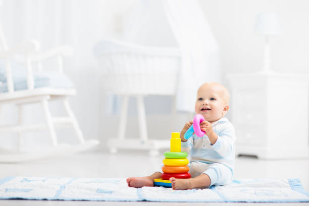 istock Baby playing with toy pyramid. Kids play 2145381086