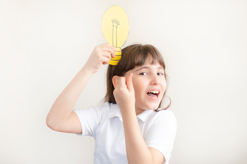 Girl Holding Light Bulb On Head