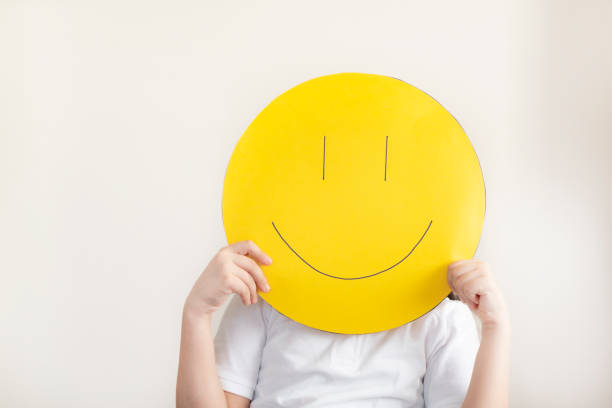 Happy girl with smiley faces drawing