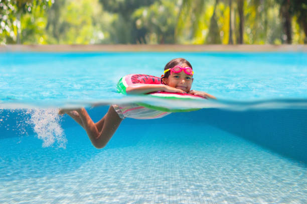 istock Child in swimming pool on toy ring. Kids swim. 2145409721
