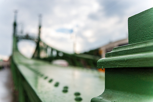 Closeup of a raindrop hanging on Budapest's famous bridge