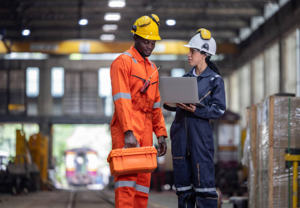 istock Engineer supervisor uses laptop for train diagnostics, maintenance, and CO2 reduction discussions. 2145433804