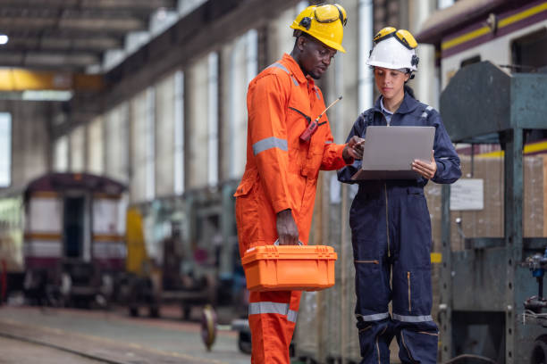 istock Engineer supervisor uses laptop for train diagnostics, maintenance, and CO2 reduction discussions. 2145440953