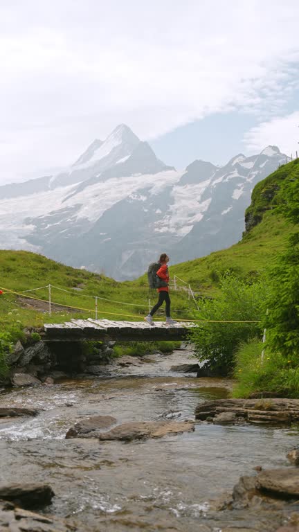 Cheerful woman on hiking trail in Switzerland