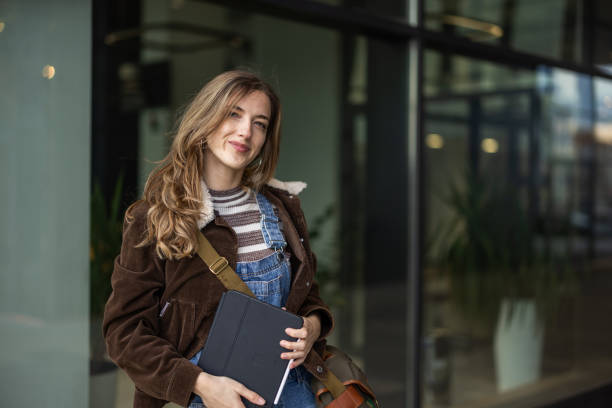 istock Portrait of beautiful young student in front of university building 2145515216