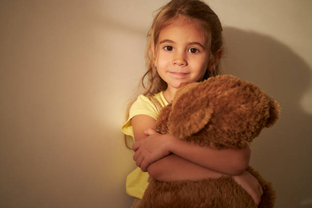 istock Beautiful girl hugging her Teddy Bear 2145544561