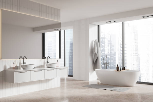 istock Modern home bathroom interior with bathtub, double sink and panoramic window 2145545067