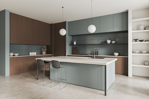 Corner of modern kitchen with white and wooden walls, concrete floor, gray cupboards and cabinets and cozy gray island with stools. 3d rendering