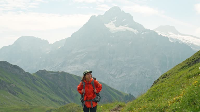 Cheerful woman on hiking trail in Switzerland