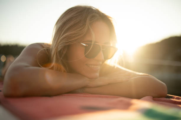 istock A beautiful young woman lying on a sailboat deck while sailing 2145583779