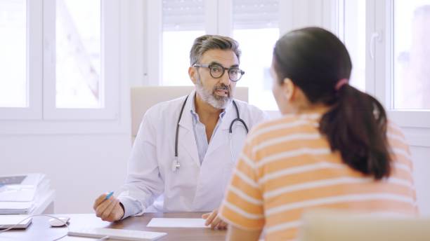 istock Doctor writing down notes and talking to a woman 2145592048