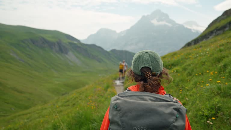 Cheerful woman on hiking trail in Switzerland