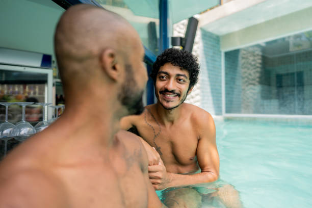 istock Friends talking at swimming pool bar 2145669035