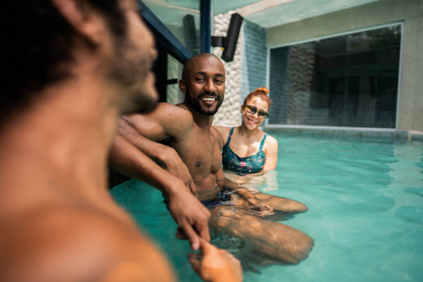 istock Friends talking at swimming pool bar 2145669575