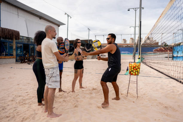 istock Instructor teaching tennis players on a tennis beach venue 2145688774