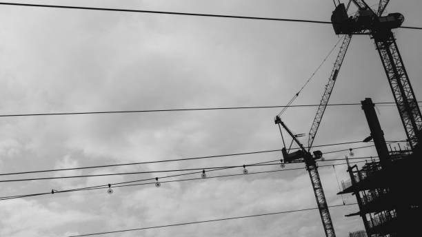 istock Construction Cranes Looking Up. Cloudy Day Atmospheric Cables and Wires Foreground 2145725843