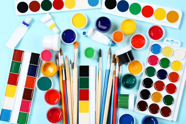 istock Colorful gouache paints and brushes on blue background 2145754963
