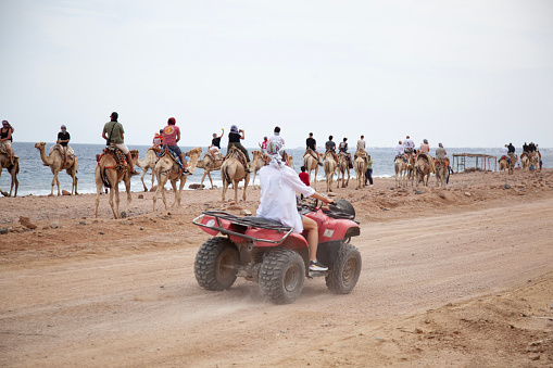 Hurghada, Egypt - December 10, 2018: Safari trip through egyptian desert driving ATV. Quad bikes safari in the desert near Hurghada, Egypt