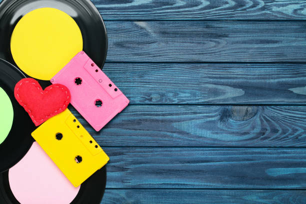 istock Cassette tapes with vinyl records and fabric heart on blue background 2145778212