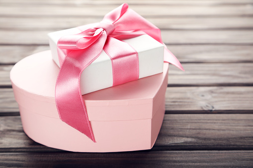 Heart shaped gift box on bown wooden table