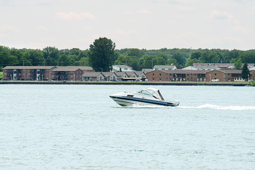 small runabout boat on st clair river ontario with usa in the background