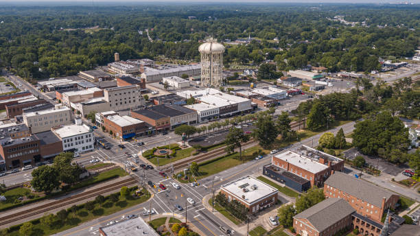 istock Cell Tower development in Thomasville, NC. Water tower with cell antennas on Main Street. Buildings and crossroads townscape 2145868039